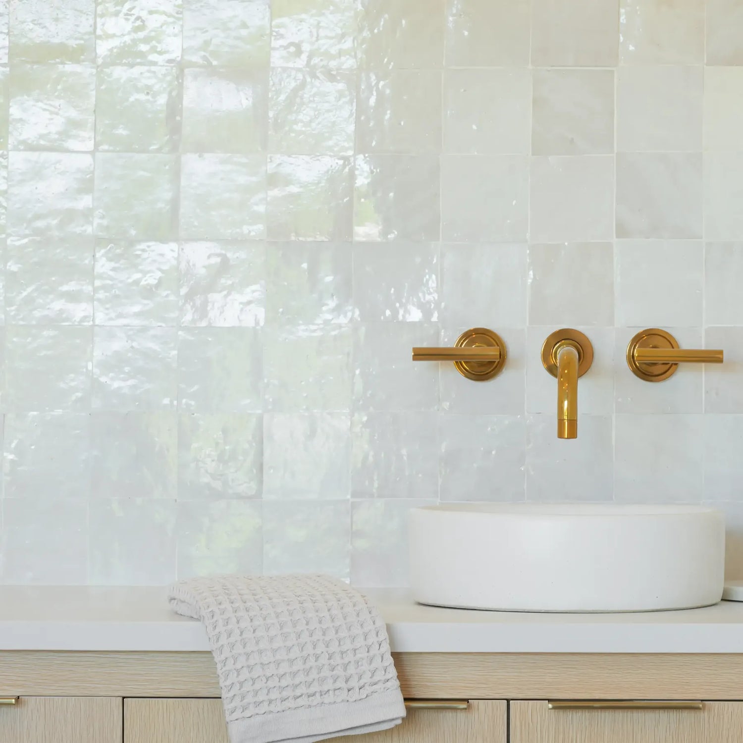 A white sink with a gold faucet, showcasing a harmonious blend of luxury and modern aesthetics at Grayce Skin Co.